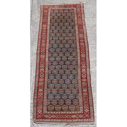 381 - Property of a lady - an early 20th century Kurdish long rug, 116 by 42ins. (294 by 107cms.).