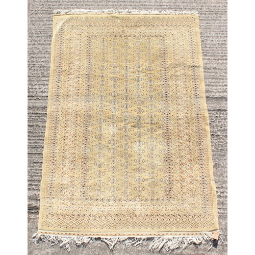 379 - Property of a gentleman - a finely knotted Turkoman design rug with pale yellow ground, 74 by 51ins.... 