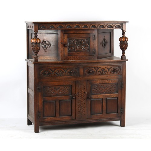 420 - Property of a deceased estate - a reproduction carved oak court cupboard, 49ins. (124.5cms.) long.