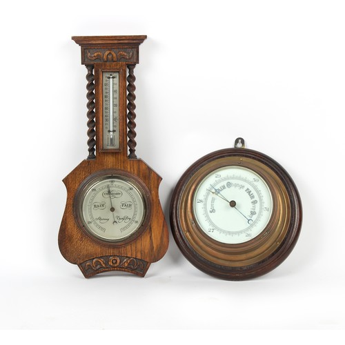 412 - Property of a deceased estate - a brass cased bulkhead aneroid barometer, mounted on an oak roundel,... 