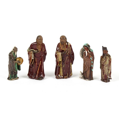 64 - Property of a gentleman - three Chinese Shiwan figures, the tallest 12ins. (30.5cms.) high; together... 