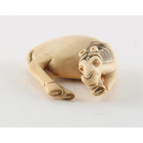 224 - Property of a gentleman - a Japanese carved ivory netsuke modelled as a grazing horse, 18th / 19th c... 