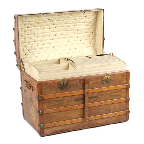 313 - Property of a deceased estate - a late 19th century tooled leather domed top trunk with fitted inter... 