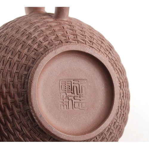 66 - Property of a lady - a Chinese Yixing teapot, with moulded basketweave decoration, signed to base & ... 