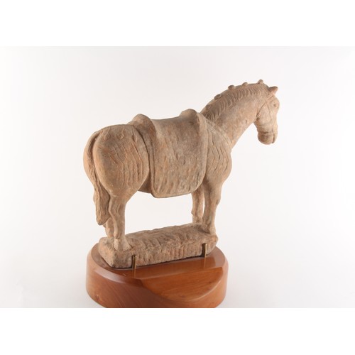 63 - Property of a gentleman - a Chinese Tang style pottery model of a horse, on wooden stand, 13.75ins. ... 