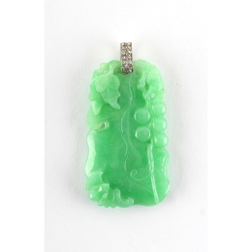 18 - A very good Chinese carved natural jadeite pendant with diamond set suspension loop, the evenly colo... 