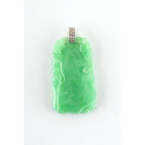 18 - A very good Chinese carved natural jadeite pendant with diamond set suspension loop, the evenly colo... 