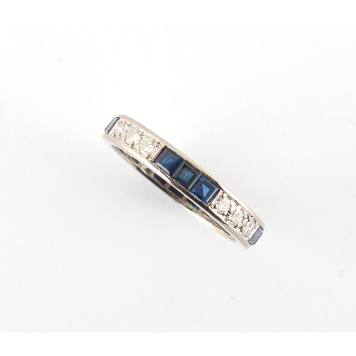 2 - A platinum sapphire & diamond eternity ring, set with alternating rows of three square cut sapphires... 