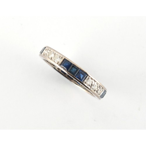 2 - A platinum sapphire & diamond eternity ring, set with alternating rows of three square cut sapphires... 