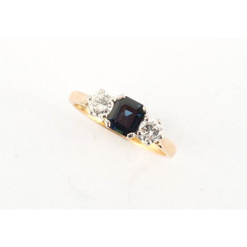 3 - An 18ct yellow gold sapphire & diamond three stone ring, the octagonal cut sapphire weighing approxi... 