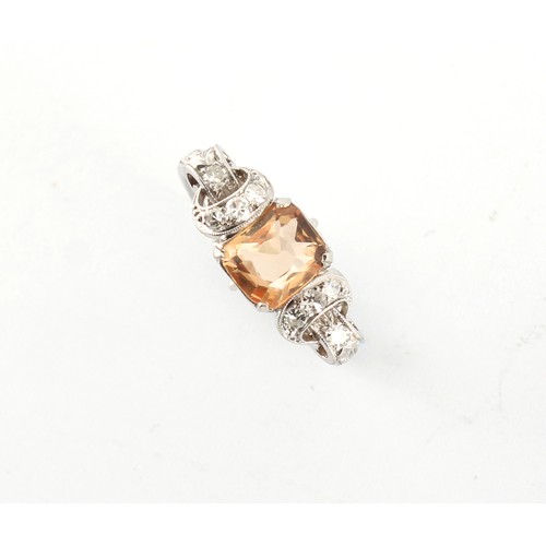 6 - An early 20th century white metal (probably platinum) topaz & diamond ring, with ornately pierced mi... 