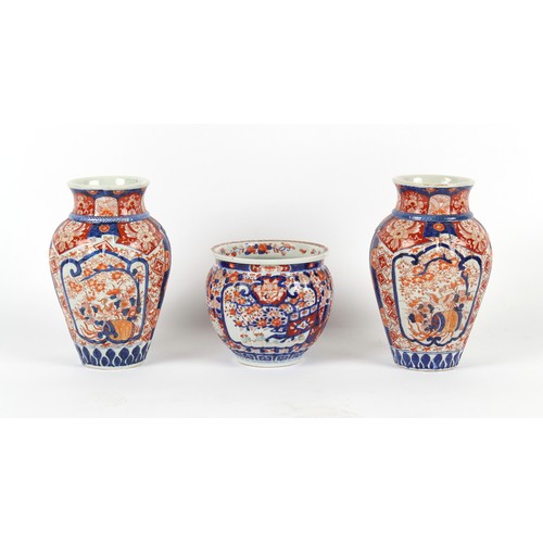 217 - A pair of late 19th century Japanese Imari vases, of moulded fluted form, each 12ins. (30.5cms.) hig... 