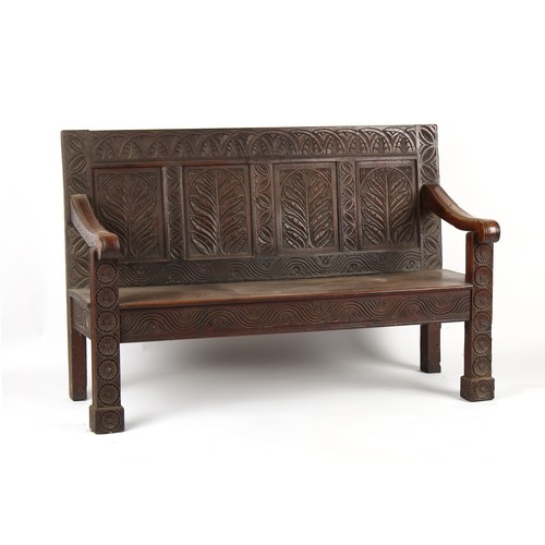 475 - Property of a deceased estate - an 18th century & later carved oak settle, 62ins. (157.5cms.) wide.