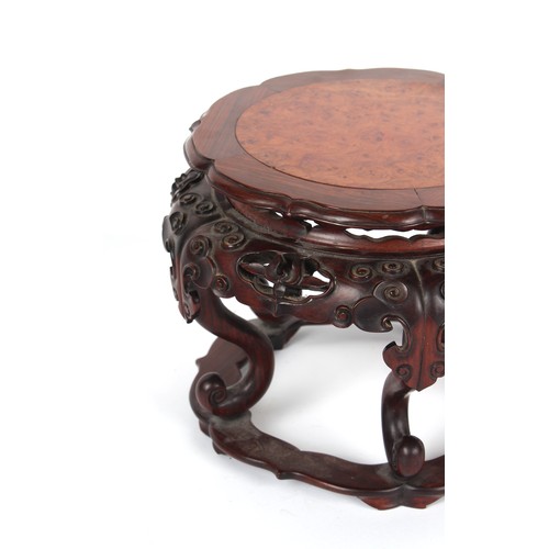 161 - A Chinese hongmu & burr wood stand, well carved with lingzhi, 11.8ins. (30cms.) diameter (overall).