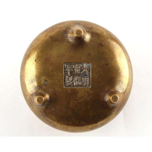 194 - A Chinese bronze two-handled tripod censer of bombe form, 18th century, Xuande 6-character mark to b... 