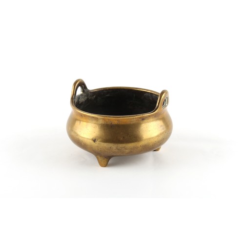 194 - A Chinese bronze two-handled tripod censer of bombe form, 18th century, Xuande 6-character mark to b... 