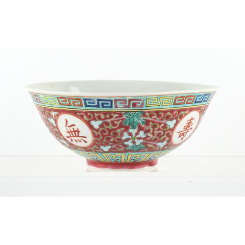 157 - A Chinese famille rose ruby ground medallion bowl, probably Republic period (1912-49), short hairlin... 