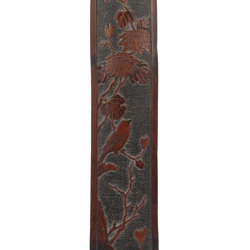 187 - A Chinese carved bamboo long panel, late 19th / early 20th century, depicting a bird in flowering sh... 