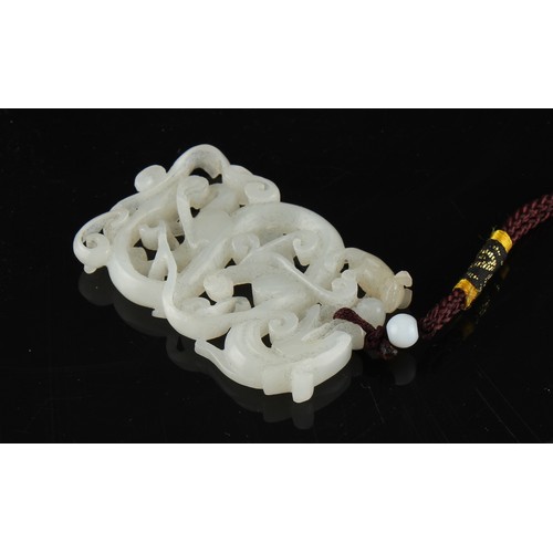 177 - Property of a lady - a Chinese carved white jade chilong pendant, the jade 58mm long.