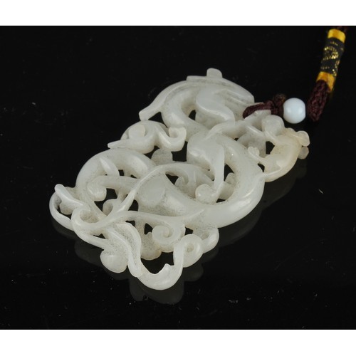 177 - Property of a lady - a Chinese carved white jade chilong pendant, the jade 58mm long.