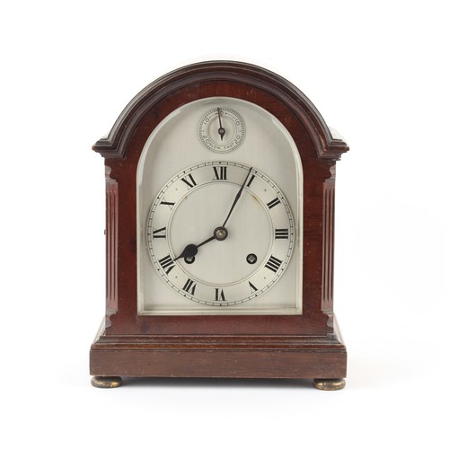 243 - The Henry & Tricia Byrom Collection - a mahogany arched cased mantel clock, with arched silvered dia... 