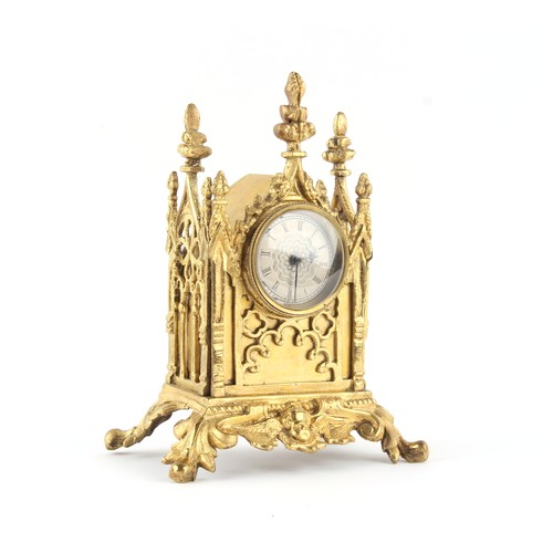 252 - The Henry & Tricia Byrom Collection - a small gilt metal gothic cased mantel clock timepiece, the po... 