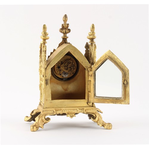 252 - The Henry & Tricia Byrom Collection - a small gilt metal gothic cased mantel clock timepiece, the po... 