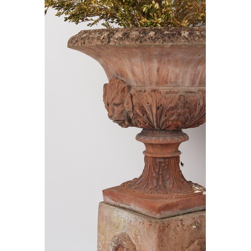 533 - Property of a gentleman - a pair of well weathered terracotta garden urns on separate plinths, with ... 