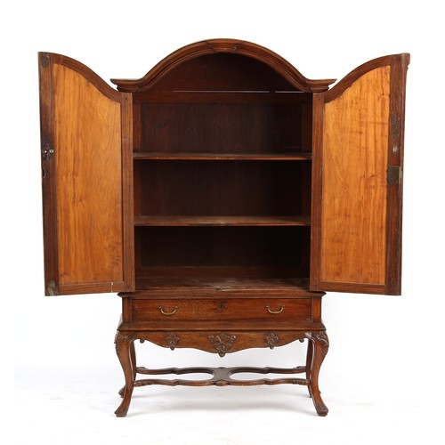 313 - Property of a lady - a late 18th century Dutch carved walnut arched two door cabinet, with fielded p... 