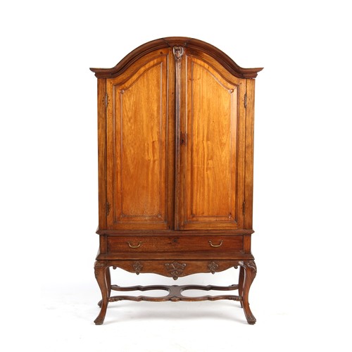 313 - Property of a lady - a late 18th century Dutch carved walnut arched two door cabinet, with fielded p... 