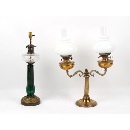 A Victorian octagonal green glass paraffin oil lamp, with clear glass