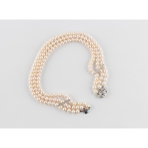 74 - Property of a lady - a cultured pearl three row necklace with 18ct white gold diamond clasp & spacer... 