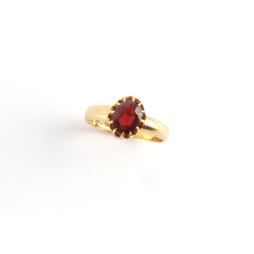 36 - A gent's 18ct yellow gold garnet ring, the oval cut garnet in claw setting, approximately 4.9 grams,... 