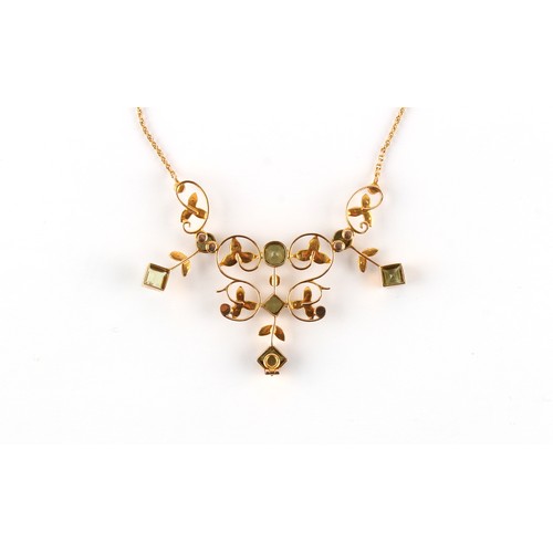 63 - An Edwardian 15ct gold peridot & seed pearl pendant on 15ct gold chain necklace, 16.15ins. (41cms.) ... 