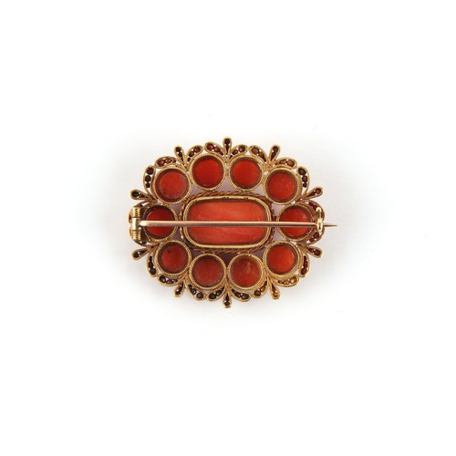 29 - A late 19th / early 20th century unmarked gold (tested) carved coral oval brooch, 34mm wide (excludi... 