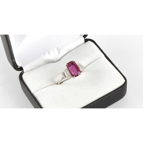 125 - An Art Deco style ruby & diamond ring, the rounded rectangular cushion cut ruby weighing approximate... 