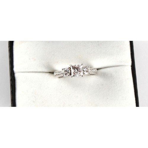 110 - A good 18ct white gold diamond three stone ring, the centre certificated princess cut diamond weighi... 