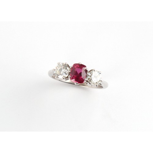 130 - An 18ct white gold certificated unheated ruby & diamond three stone ring, the oval cushion cut ruby ... 