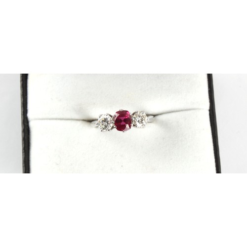 130 - An 18ct white gold certificated unheated ruby & diamond three stone ring, the oval cushion cut ruby ... 