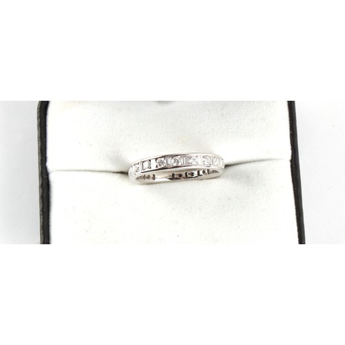 111 - An unmarked white gold diamond eternity ring, set with round brilliant cut diamonds alternating with... 