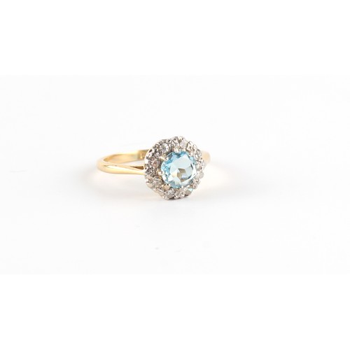 55 - An 18ct yellow gold aquamarine & diamond cluster ring, the round cut aquamarine weighing approximate... 