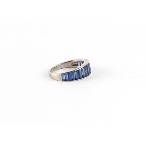 135 - An 18ct white gold sapphire ring, set with seventeen graduated baguette sapphires weighing a total o... 