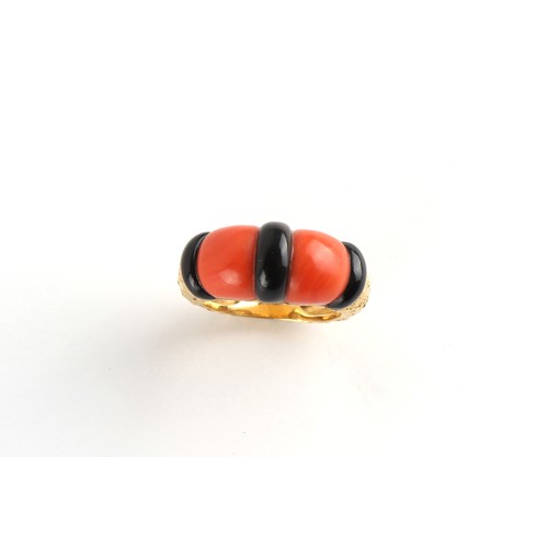 115 - Piaget - an 18ct yellow gold coral & black onyx ring, with textured shank, signed PIAGET, size L/M.