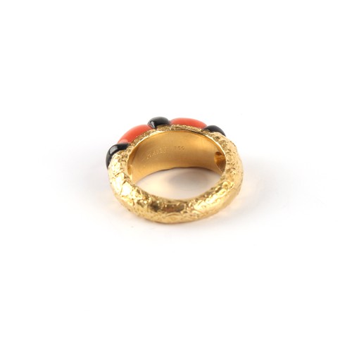 115 - Piaget - an 18ct yellow gold coral & black onyx ring, with textured shank, signed PIAGET, size L/M.