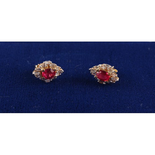 20 - A pair of 14ct yellow gold ruby & diamond earrings, with post & butterfly fastenings, each set with ... 