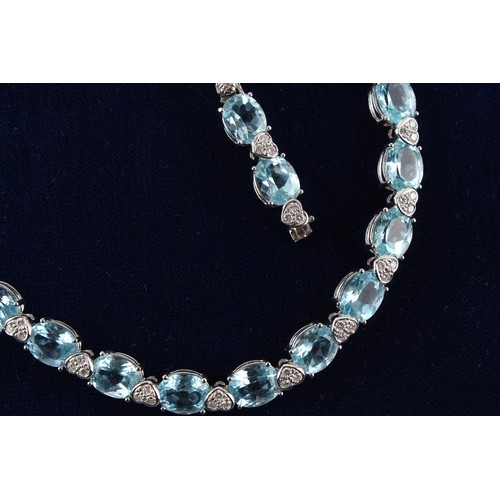 76 - A good 18ct white gold pale blue topaz & diamond riviere necklace, possibly Asprey, with twenty-nine... 