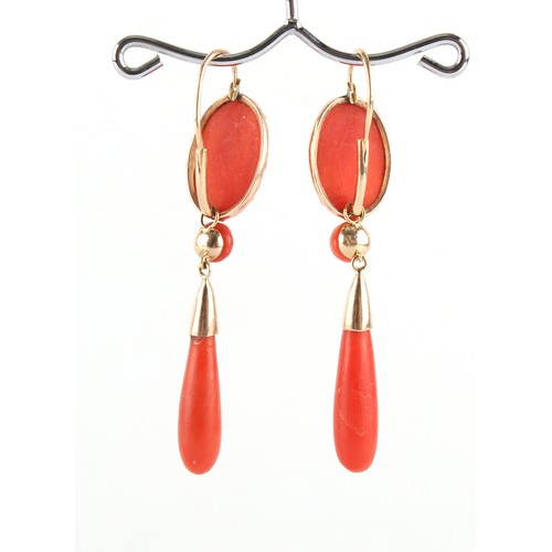 105 - A pair of 19th century carved coral drop earrings, each approximately 55mm long (2).