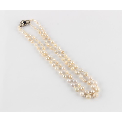 96 - A natural saltwater pearl two strand necklace, the largest barrel shaped pearl measuring approximate... 