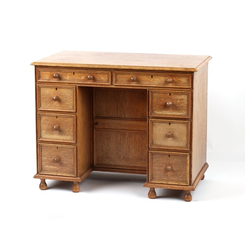 378 - Property of a deceased estate - a small Cotswold School oak kneehole desk attributed to Peter Waals ... 