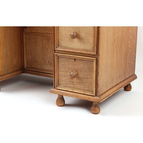 378 - Property of a deceased estate - a small Cotswold School oak kneehole desk attributed to Peter Waals ... 